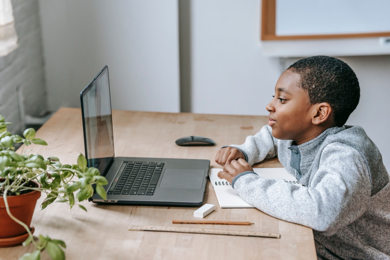 NODE Miami Youth AI Academy student, age 11 to 17, learning artificial intelligence and coding on a laptop during a hands-on class session